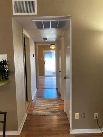 a view of hallway with wooden floor and stairs