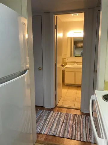 a street view of a house with a small yard and plants