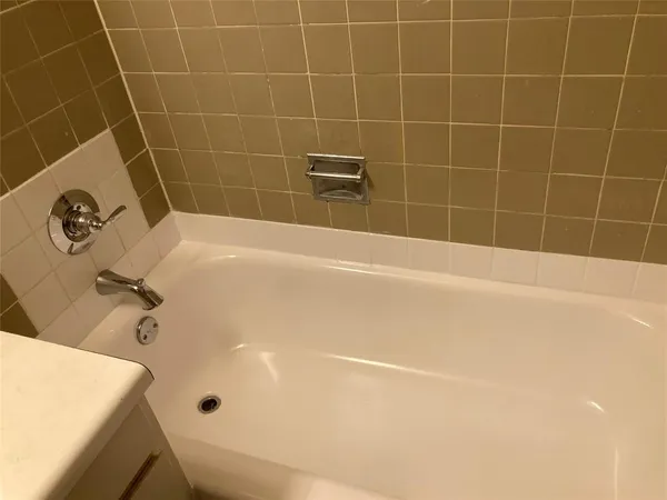 a view of a room with a ceiling fan and wooden floor