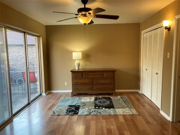 a room with a balcony and chandelier