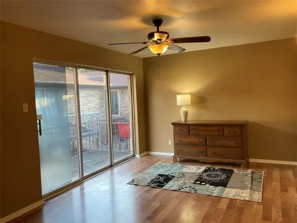 a street view of a house with a small yard and plants