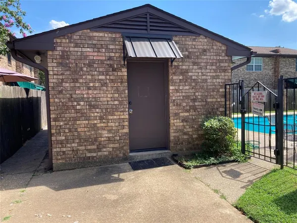 a front view of a brick house with a yard