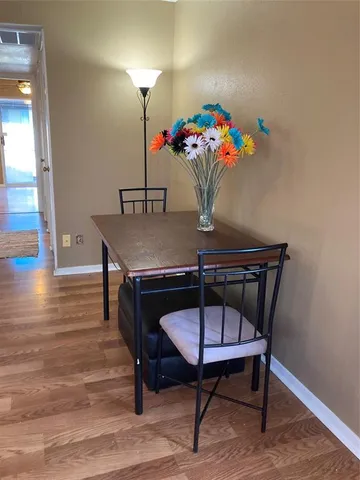 a view of a dining room with furniture and wooden floor