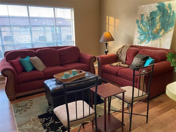 a living room with furniture a table and chair
