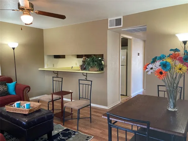 a living room with furniture and a lamp