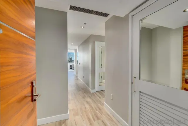 a large kitchen with stainless steel appliances a stove a sink dishwasher and a dining table with wooden floor