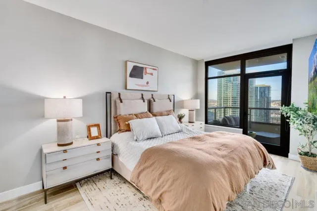 a kitchen with a refrigerator and a wooden floor