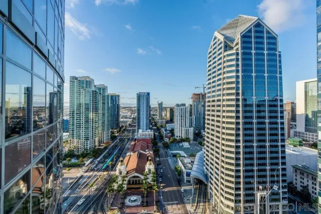a view of a living room with furniture and floor to ceiling windows