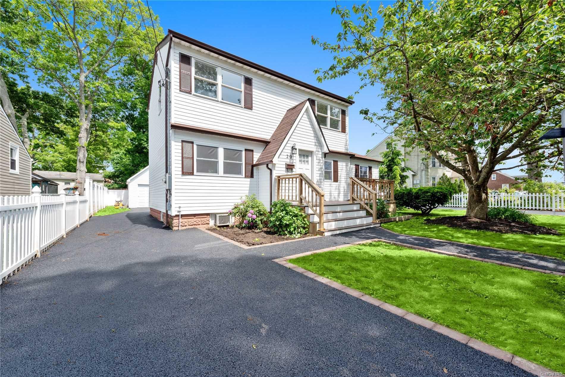 20 Rita Place Copiague, NY 11726 - Photo 1 of 1 a front view of a house with a yard and garage