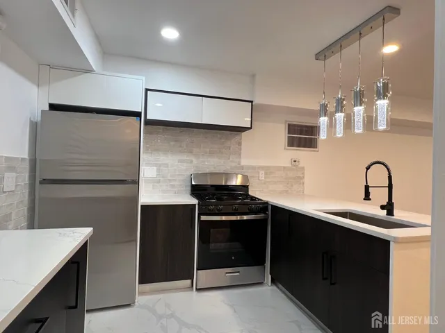 a kitchen with a sink and a refrigerator