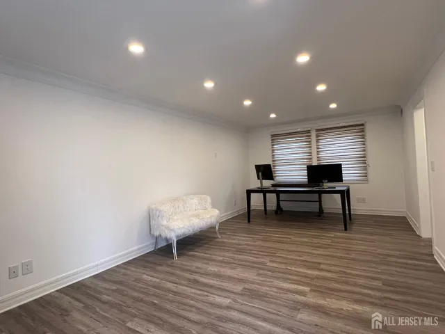 a view of a room with wooden floor and furniture