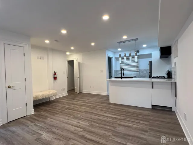 a view of kitchen with refrigerator and window