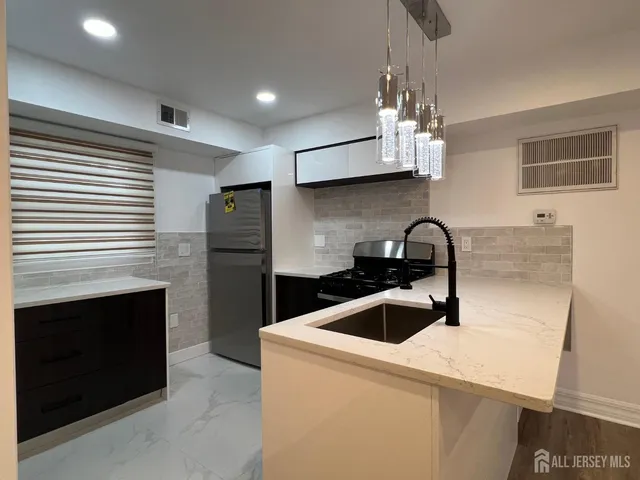a kitchen with a sink and stainless steel appliances