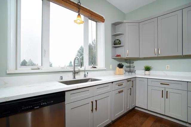 a dining room with furniture a chandelier and wooden floor