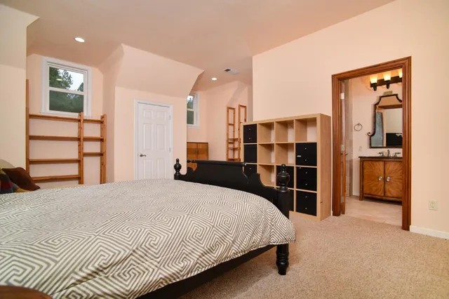 a bedroom with a bed and a dresser