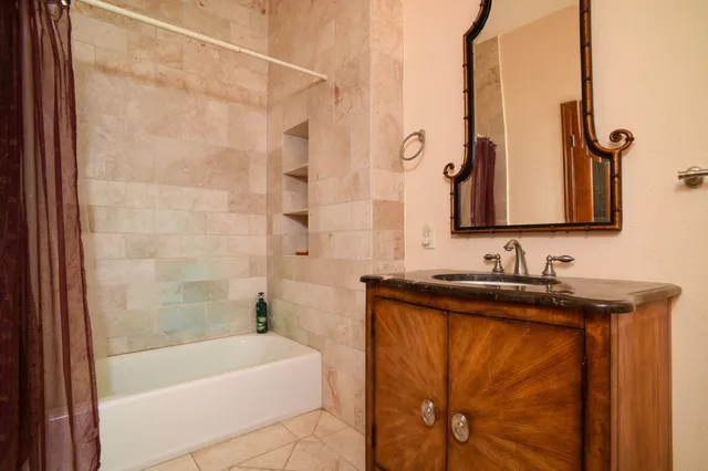 a bathroom with a sink a mirror and a bathtub