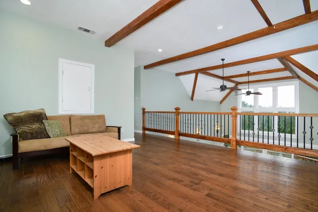 a living room with furniture and large windows