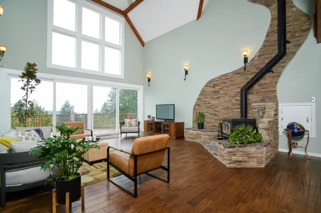 a living room with furniture fireplace and potted plants