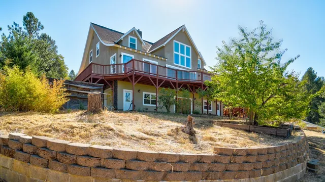 an aerial view of a house with a yard and garden