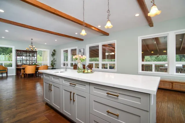 a open kitchen with stainless steel appliances granite countertop a lot of counter space and a wooden floors