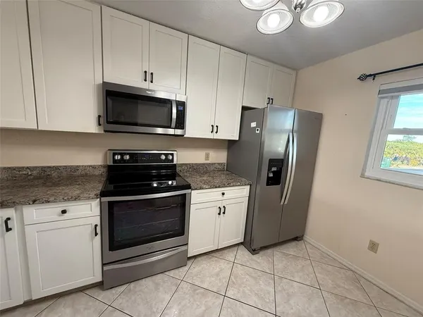 a living room with a couch and a stove top oven