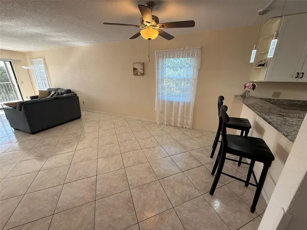 a view of a livingroom with furniture and a chandelier fan