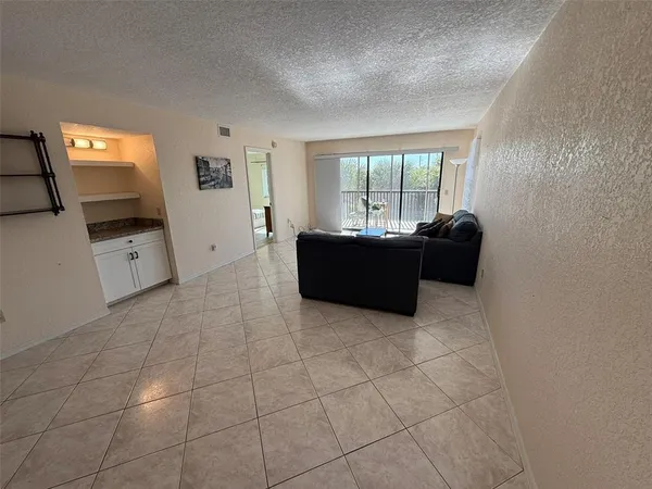 a living room with furniture and a dining table