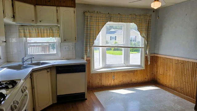 a view of a kitchen with a sink and windows