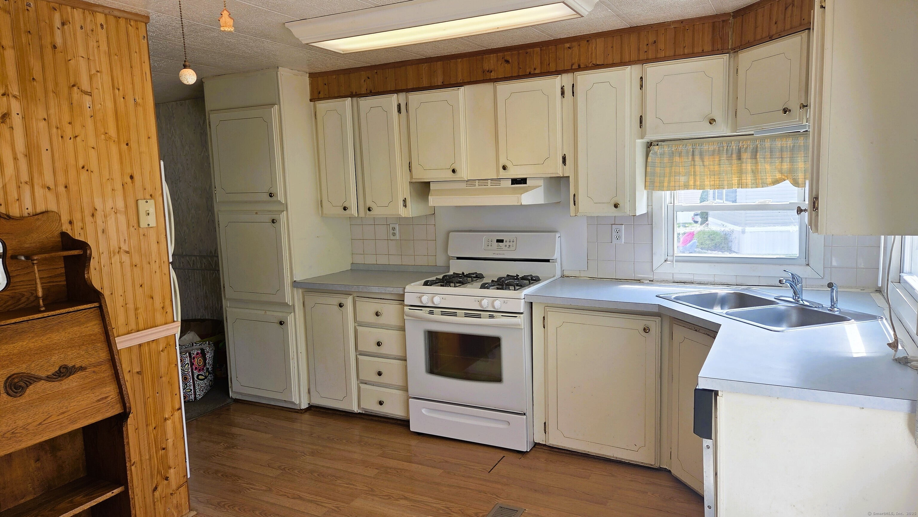 301 South Main Street Newtown, CT 06470 - Photo 5 of 11 a kitchen with a stove sink and cabinets