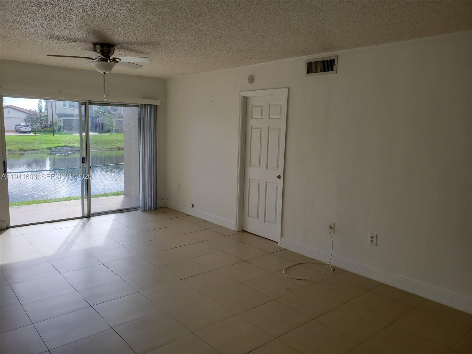 461 Southwest 113th Way, Unit 461 Pembroke Pines, FL 33025 - Photo 4 of 12 a view of an empty room with a window
