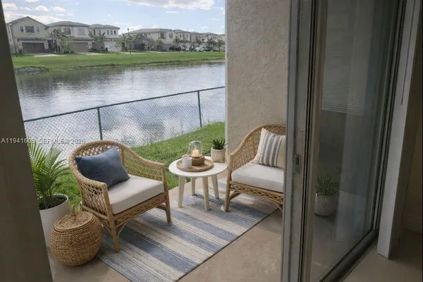 a balcony with table and chairs