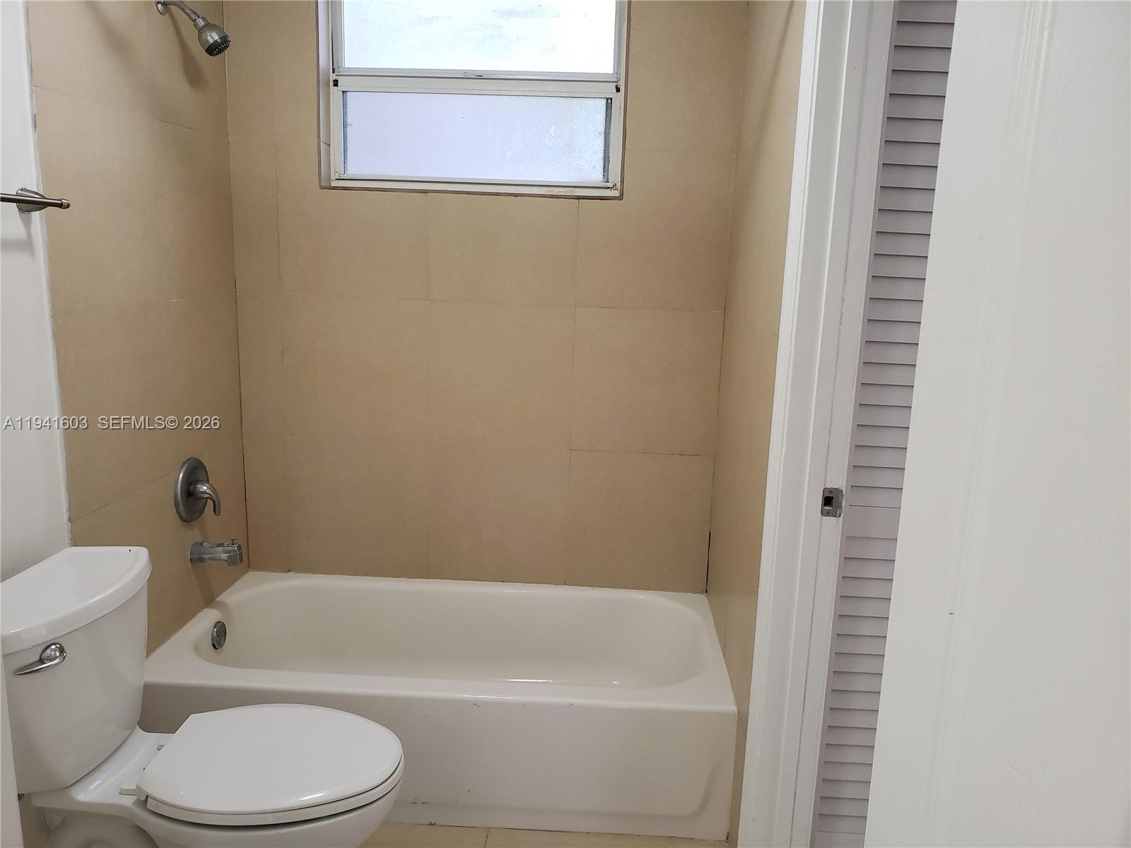 461 Southwest 113th Way, Unit 461 Pembroke Pines, FL 33025 - Photo 8 of 12 a white bath tub sitting next to a white toilet