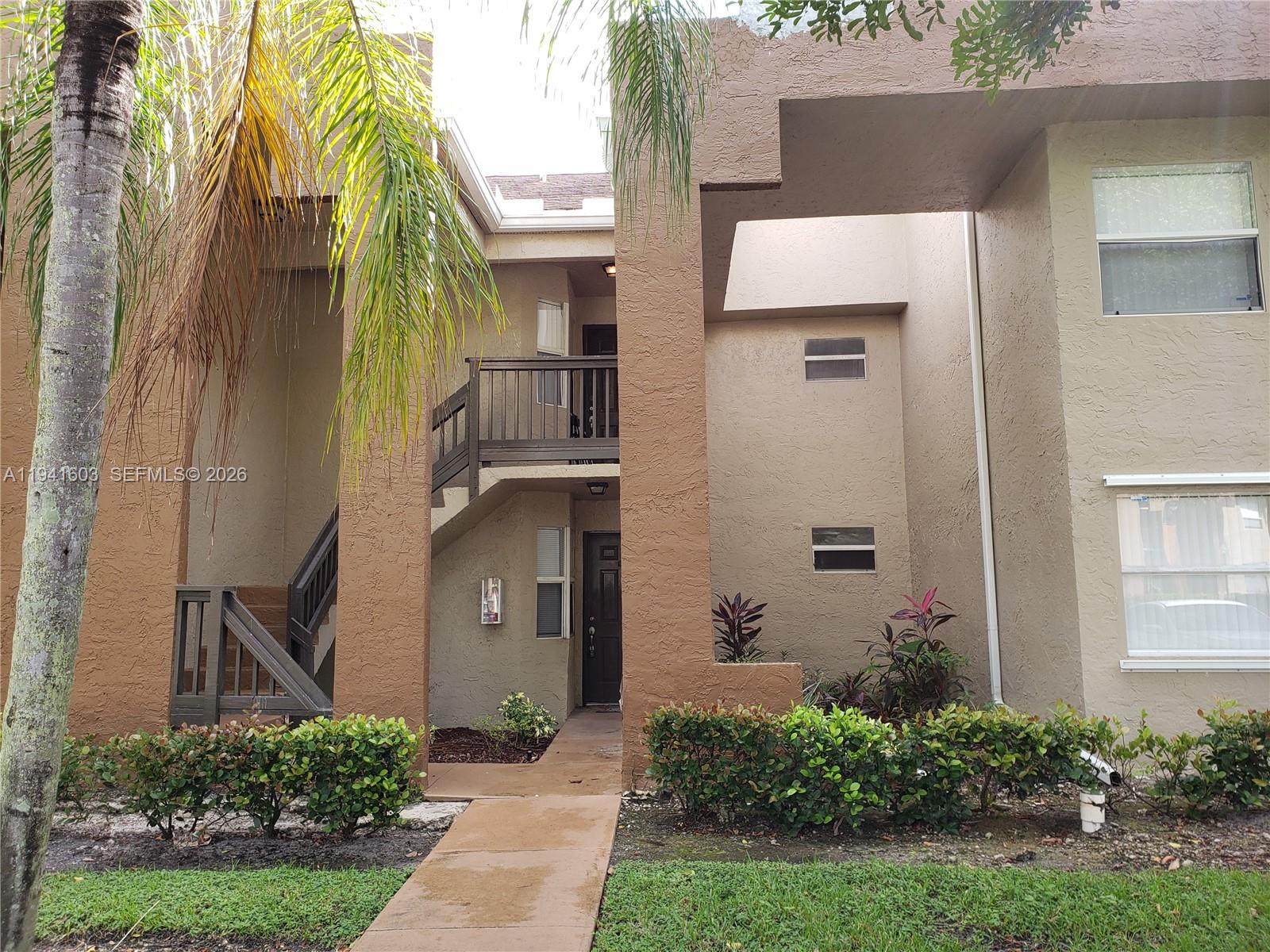 461 Southwest 113th Way, Unit 461 Pembroke Pines, FL 33025 - Photo 10 of 12 a front view of a house with a yard