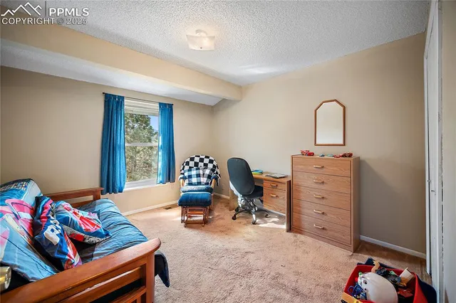 a bedroom with furniture and a window