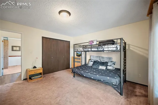 a bedroom with a bed and gym equipment