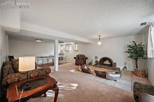 a living room with furniture a table and a potted plant