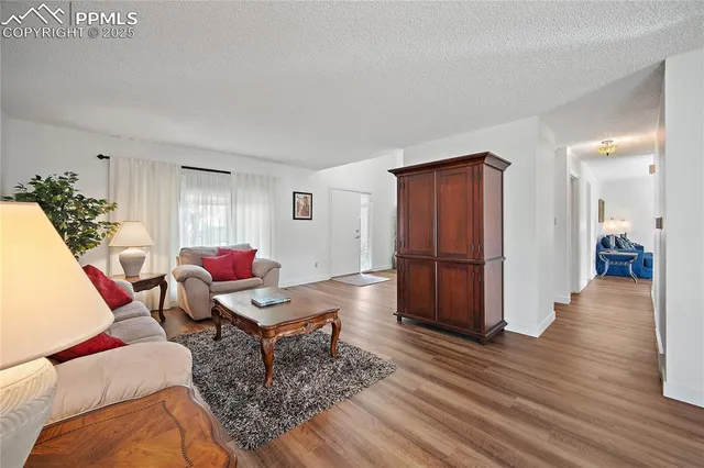 a living room with furniture and wooden floor