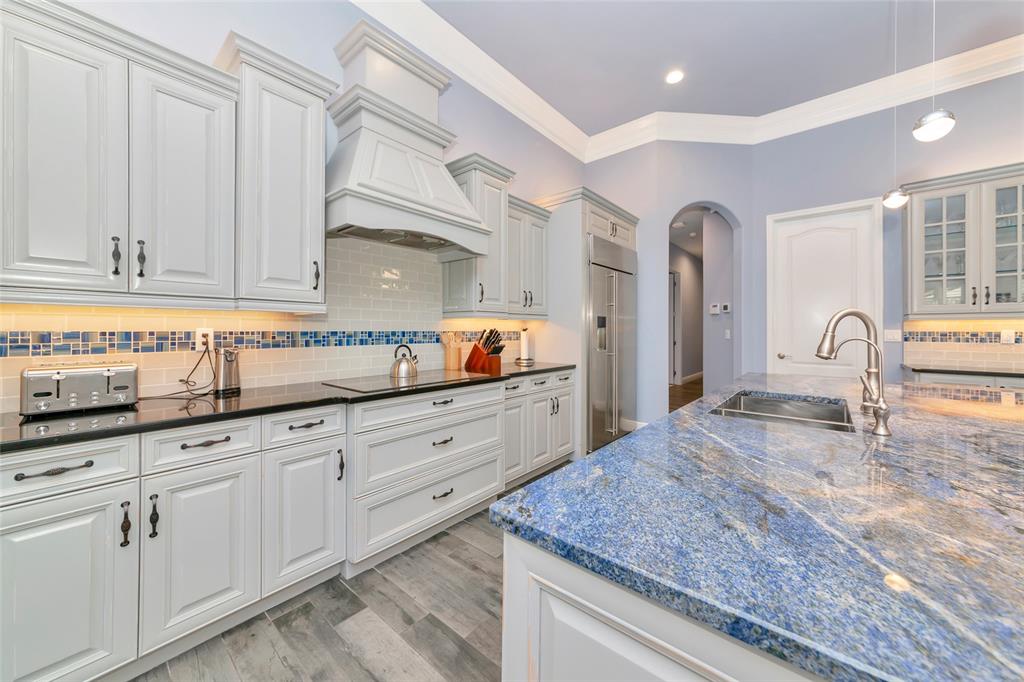 28154 Gopher Hill Road Myakka City, FL 34251 - Photo 33 of 100 a kitchen with granite countertop white cabinets and sink