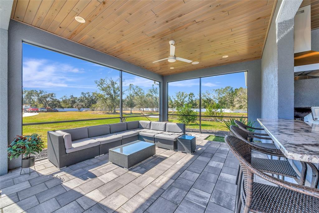 28154 Gopher Hill Road Myakka City, FL 34251 - Photo 47 of 100 a living room with patio furniture and a floor to ceiling window