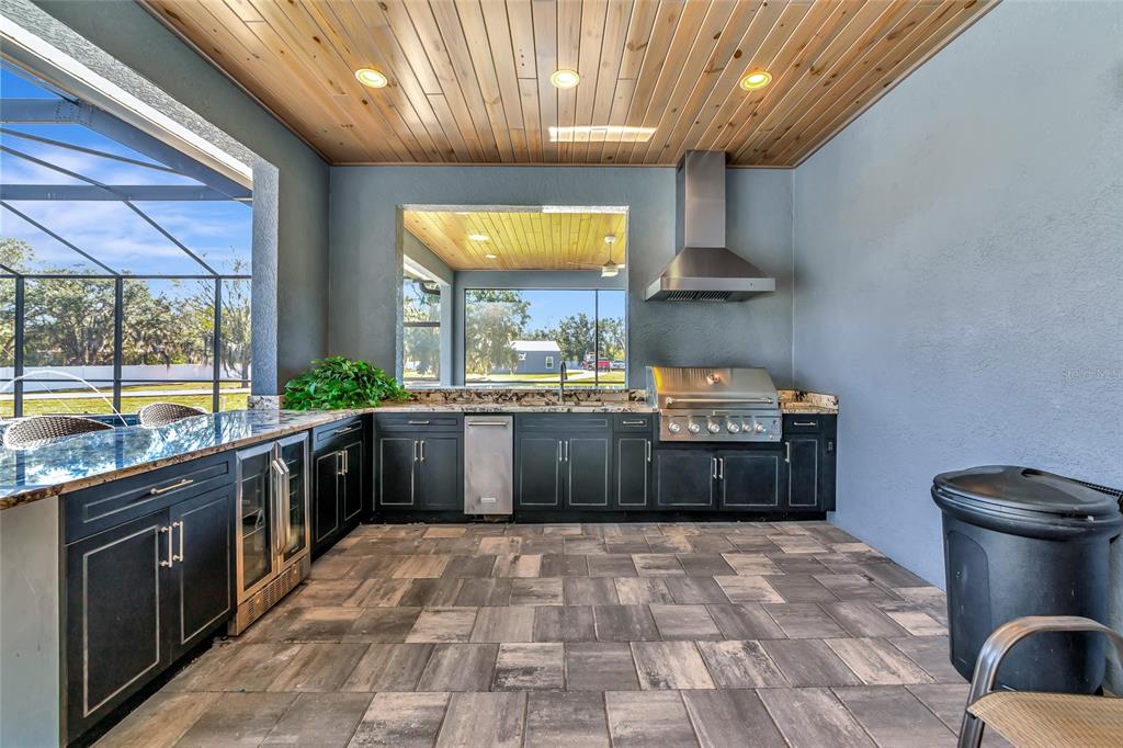 28154 Gopher Hill Road Myakka City, FL 34251 - Photo 7 of 100 a large kitchen with stainless steel appliances granite countertop a large stove a sink dishwasher and cabinets