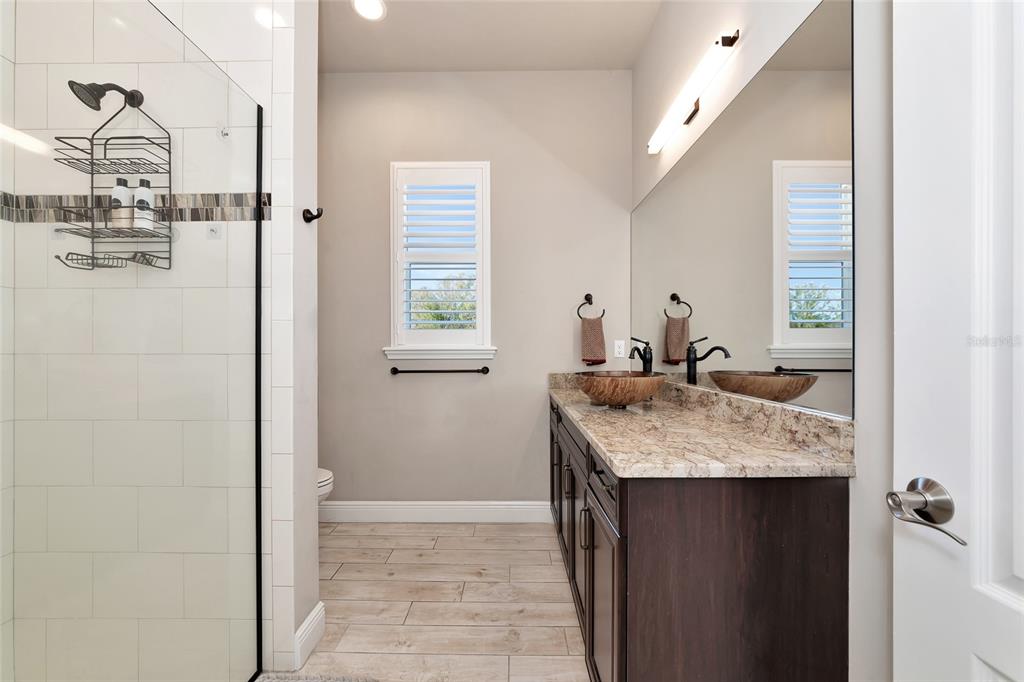 28154 Gopher Hill Road Myakka City, FL 34251 - Photo 76 of 100 a bathroom with a granite countertop sink and a mirror