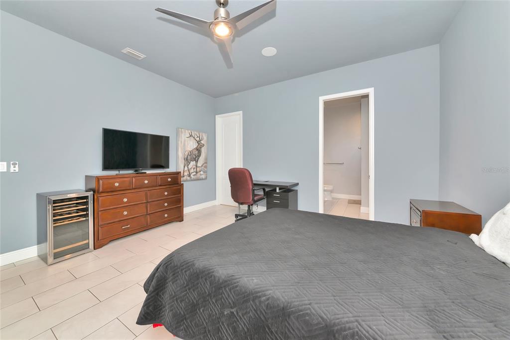28154 Gopher Hill Road Myakka City, FL 34251 - Photo 79 of 100 a bed room with furniture and a flat screen tv
