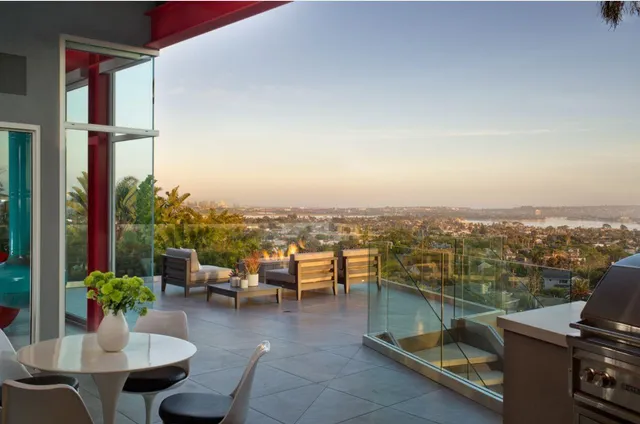 a living room with furniture and a floor to ceiling window