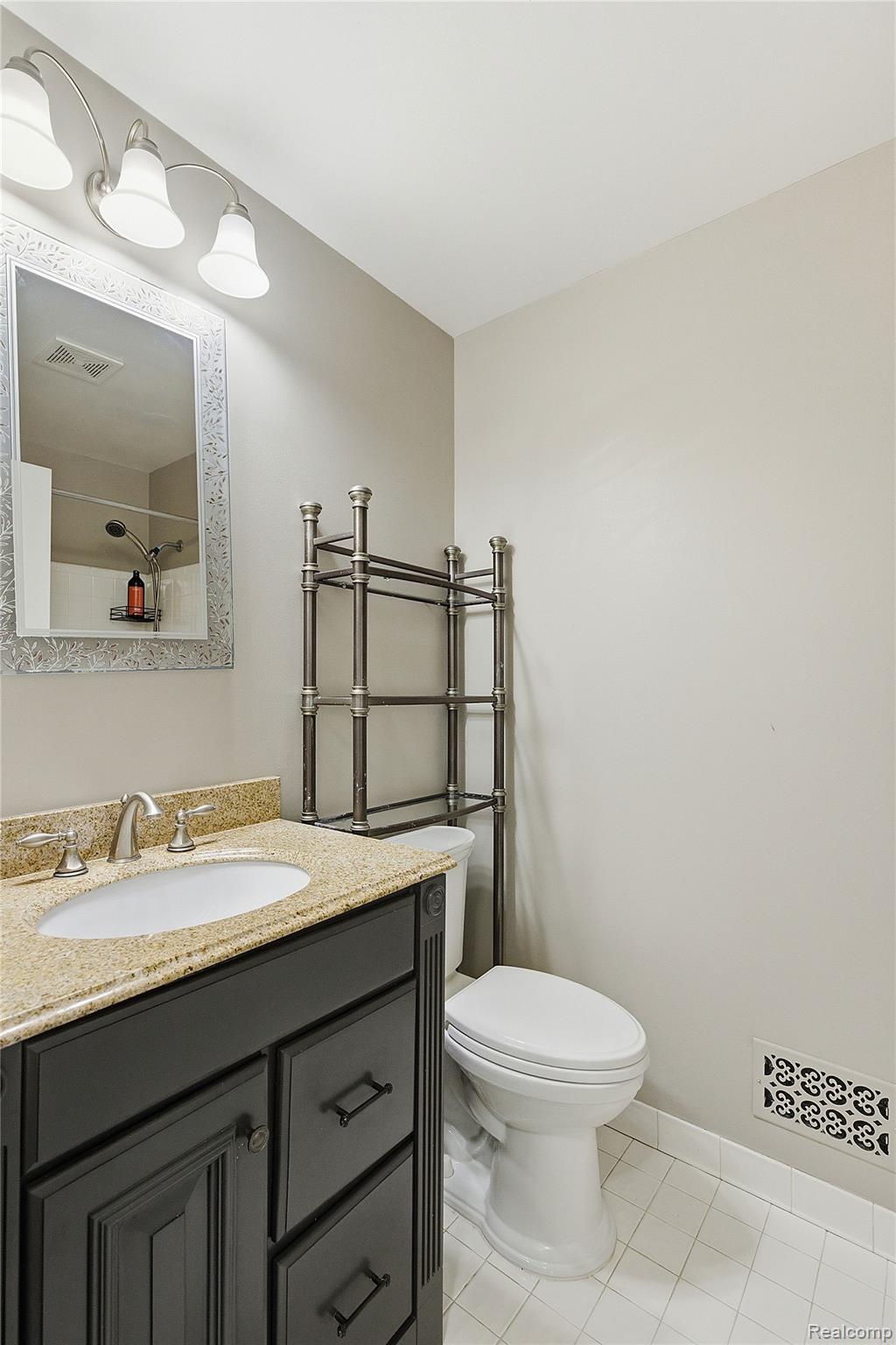 7154 Westchester Road West Bloomfield, MI 48322 - Photo 23 of 38 Bathroom with vanity, light tile patterned floors, and a shower