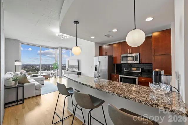 a large kitchen with a counter space and stainless steel appliances