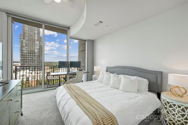 a bedroom with a large bed and a large window