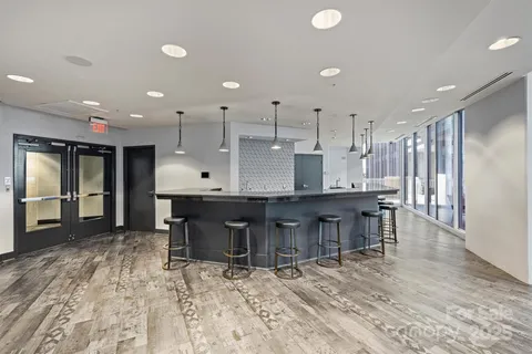 a large kitchen with a table and chairs