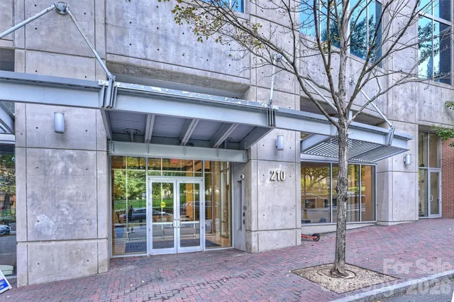 a front view of a building with a glass door and outdoor space