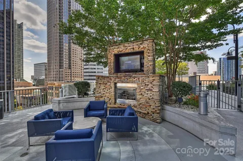 a outdoor space with patio the couches and a fireplace with wooden floor