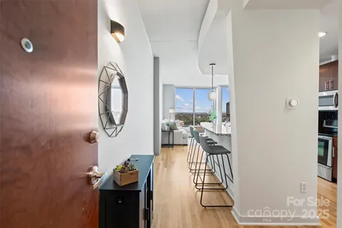a living room with furniture and a mirror